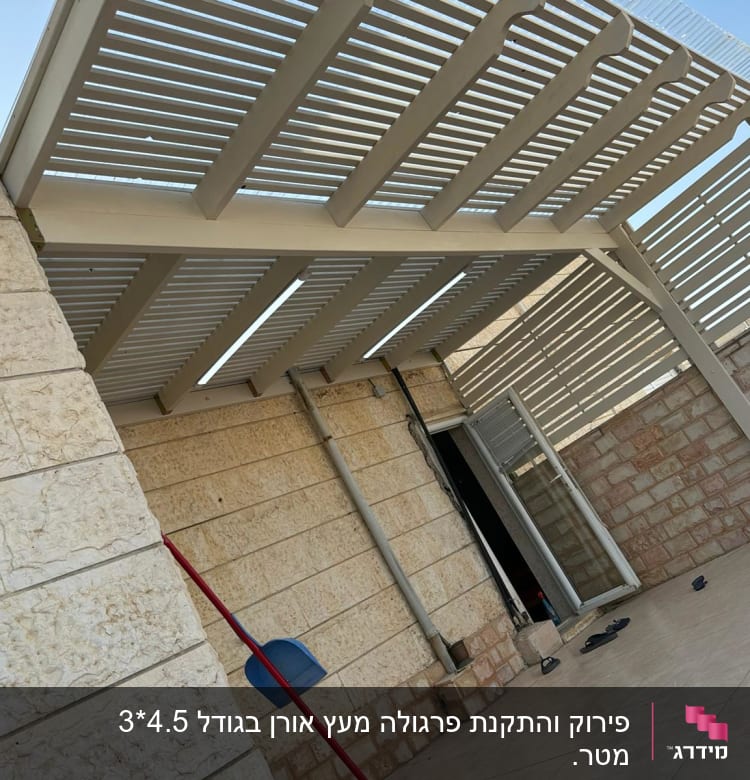 פרגולה מעץ מעל מרפסת מרוצפת אבן